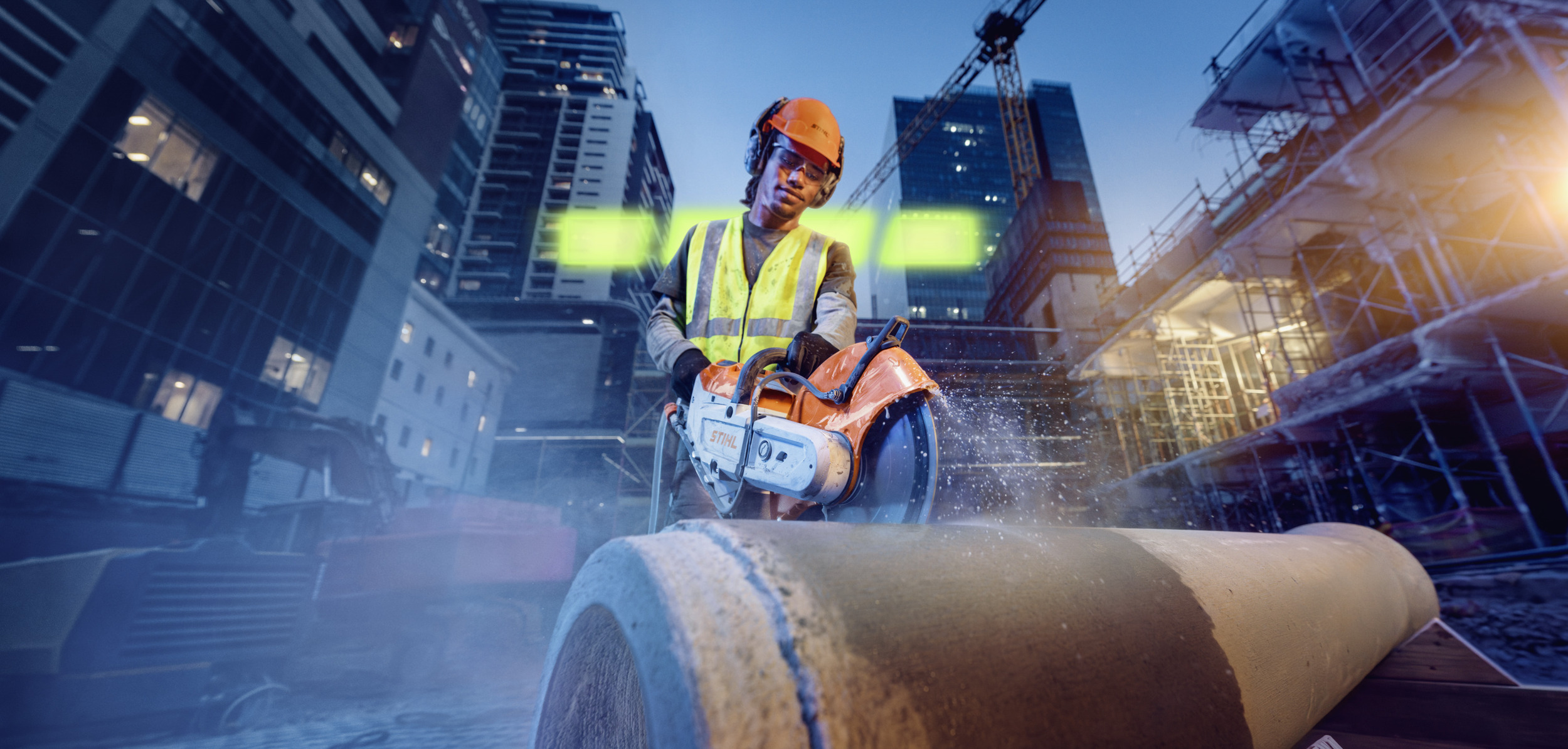 A man is cutting a concrete pipe with the TSA 350 cordless angle grinder